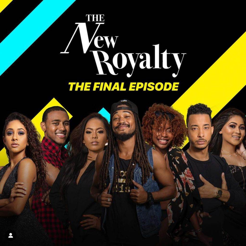 A group of seven people stands proudly before a "The New Royalty: The Final Episode" banner adorned with colorful diagonal stripes, representing the vibrant creativity of a Caribbean advertising agency based in Trinidad and Tobago.